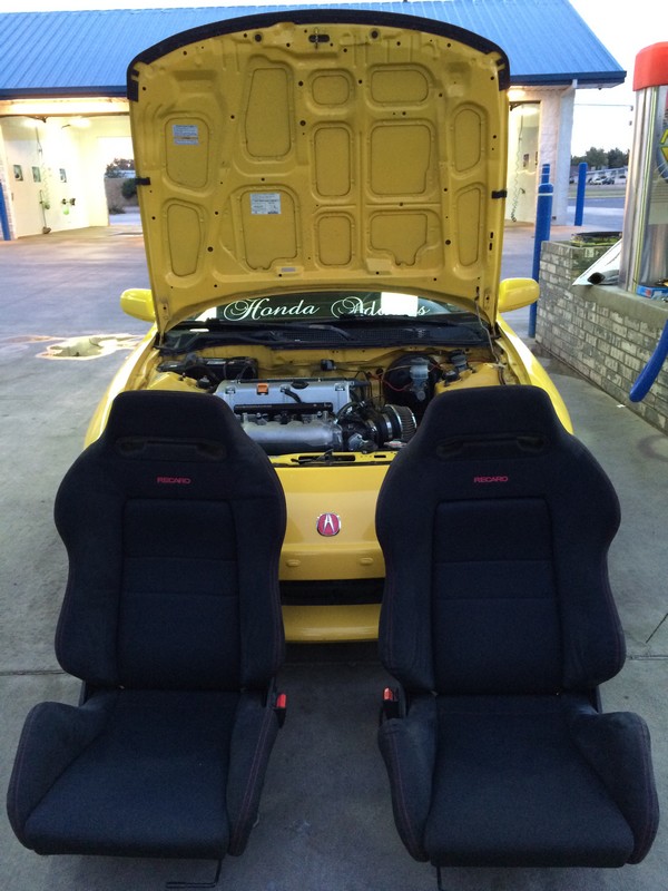 Phoenix Yellow ITR with black JDM Recaros in front of it