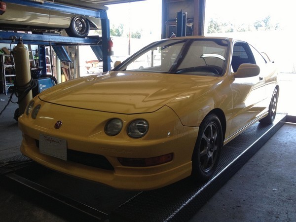 Phoenix Yellow 2000 Integra Type-R on a lift