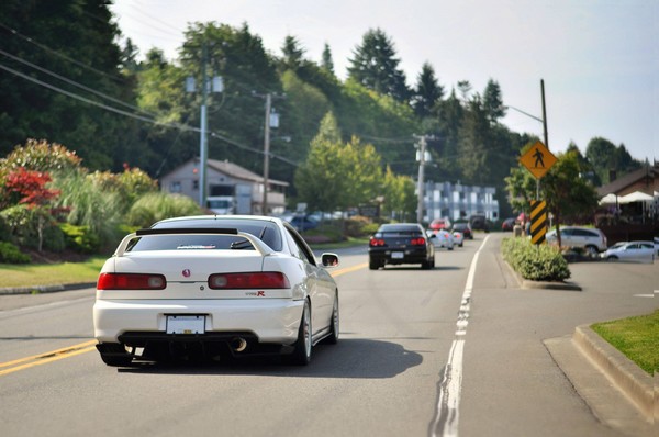 2001 Championship White Integra Type-R driving behind skyline